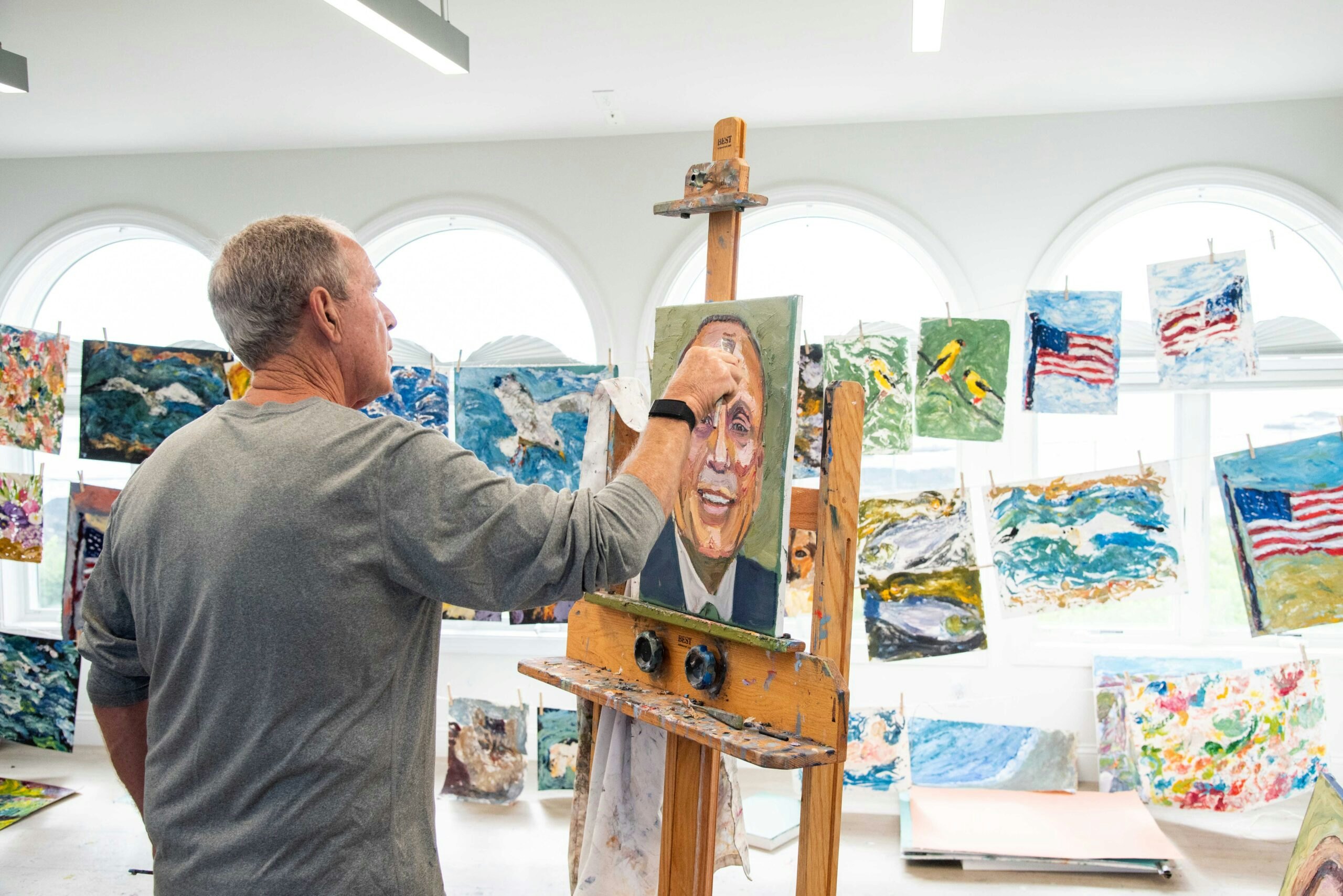 President Bush painting portraits in his studio.